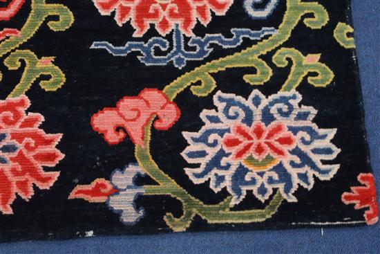 A Tibetan lotus rug, 5ft 6in. x 2ft 11in.